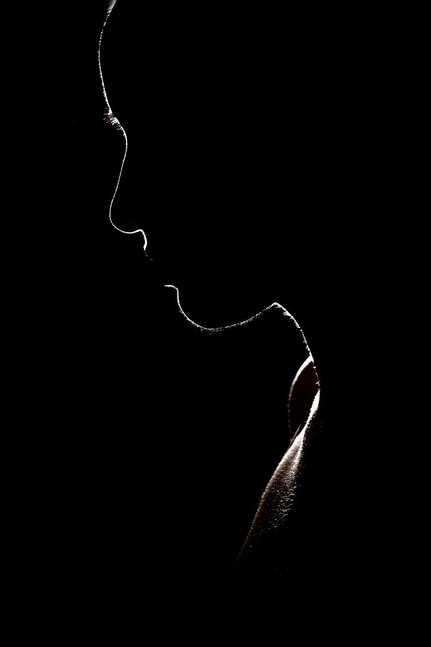 silhouette of the face and shoulders of a person of indeterminate gender.