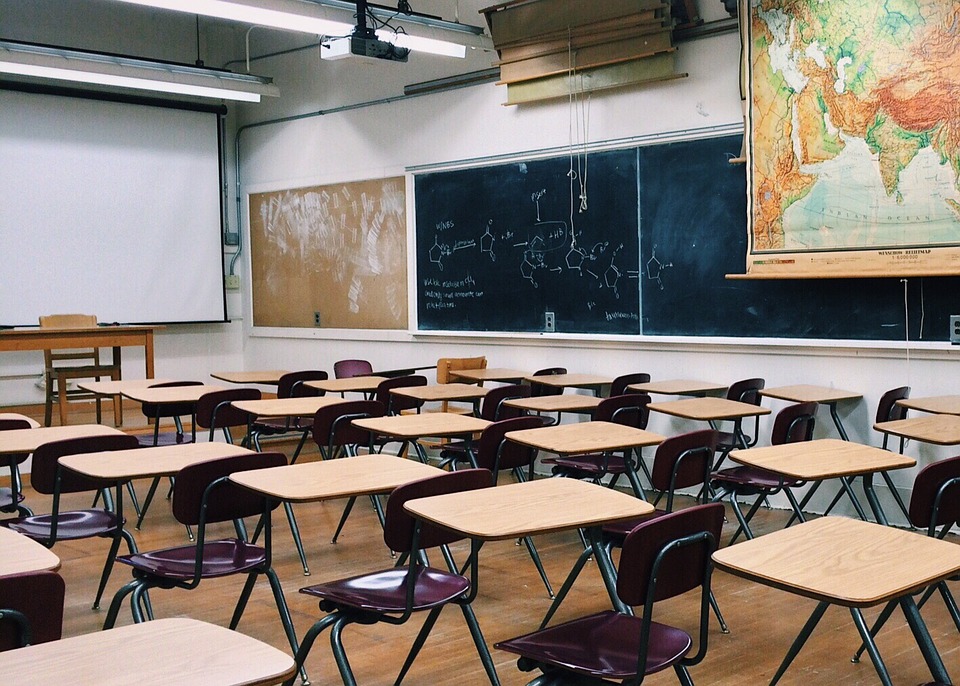 a classroom full of desks and a blackboard